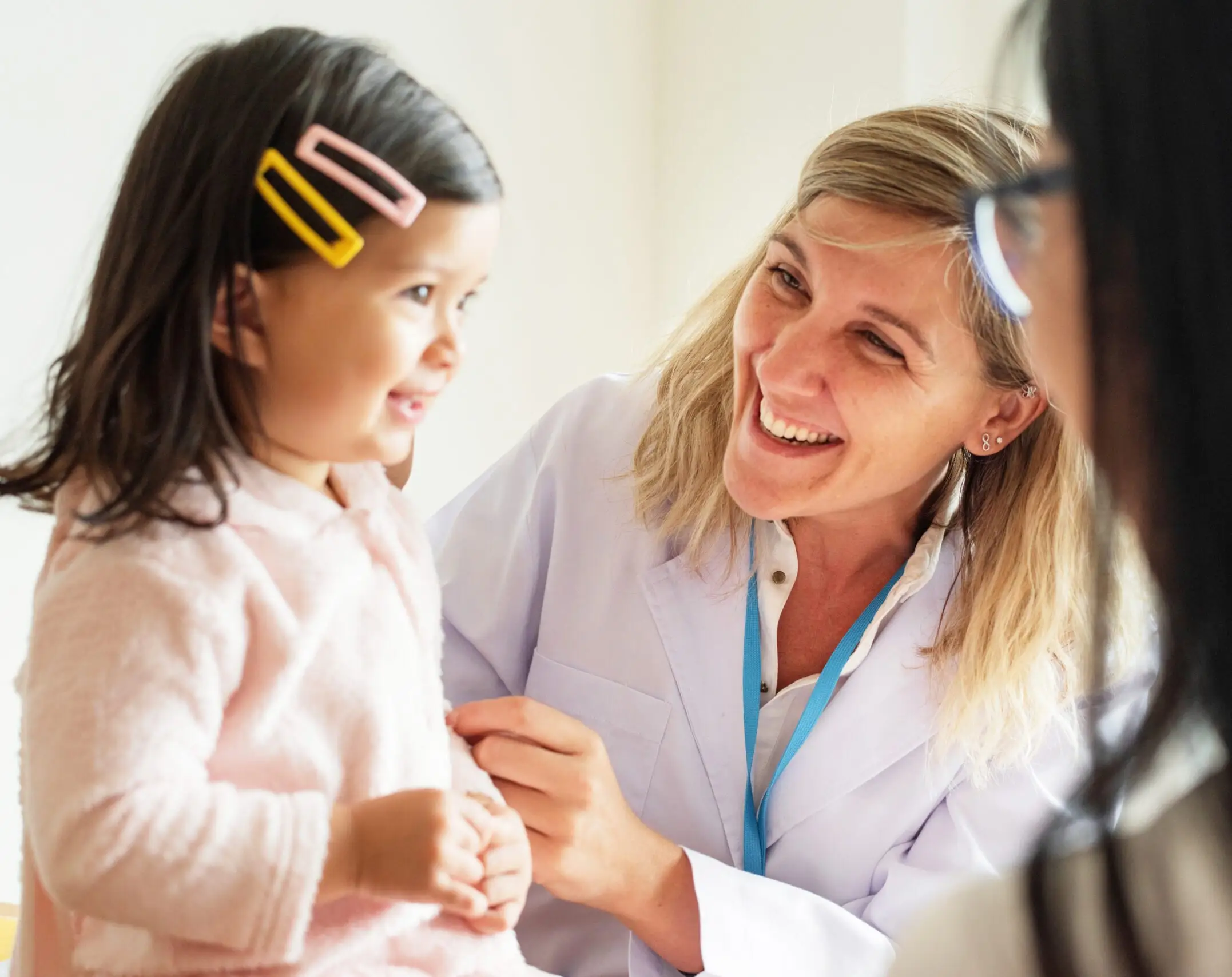 27 Pediatrician examining a little girl