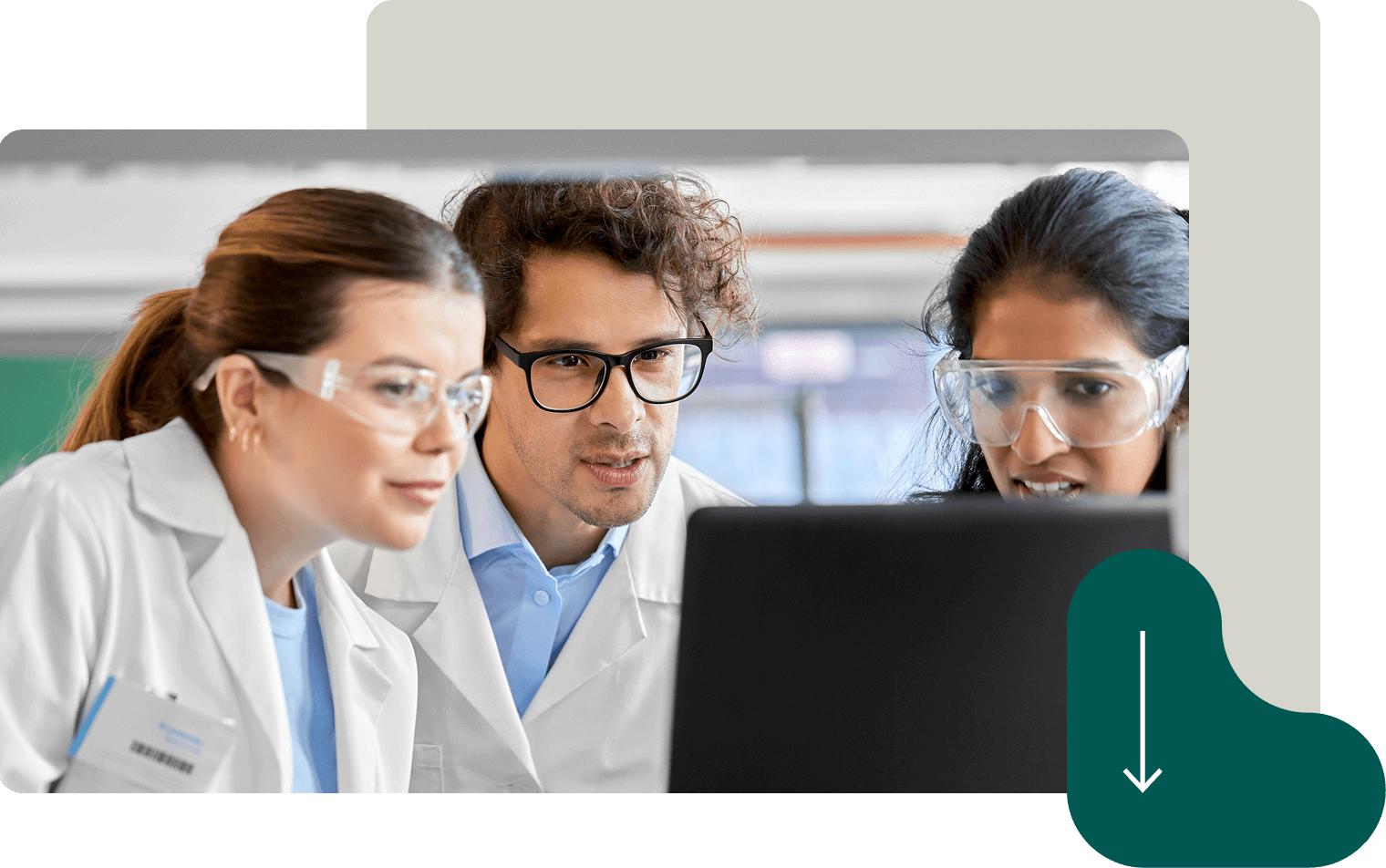 Three scientists in lab coats and safety glasses analyzing data on computer screen Three scientists in lab coats and safety glasses analyzing data on computer screen