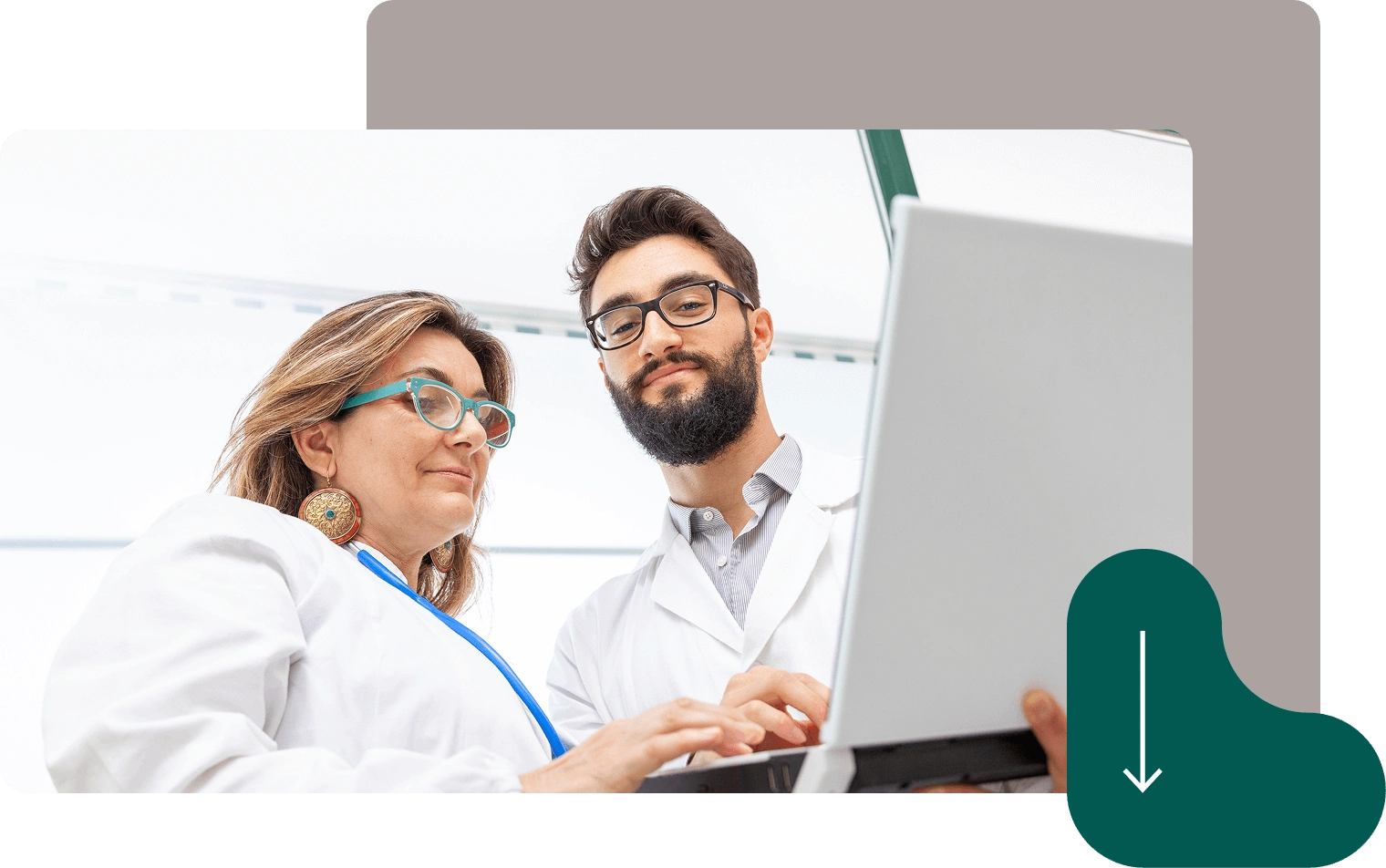 Two doctors in white coats using laptop computer for medical consultation