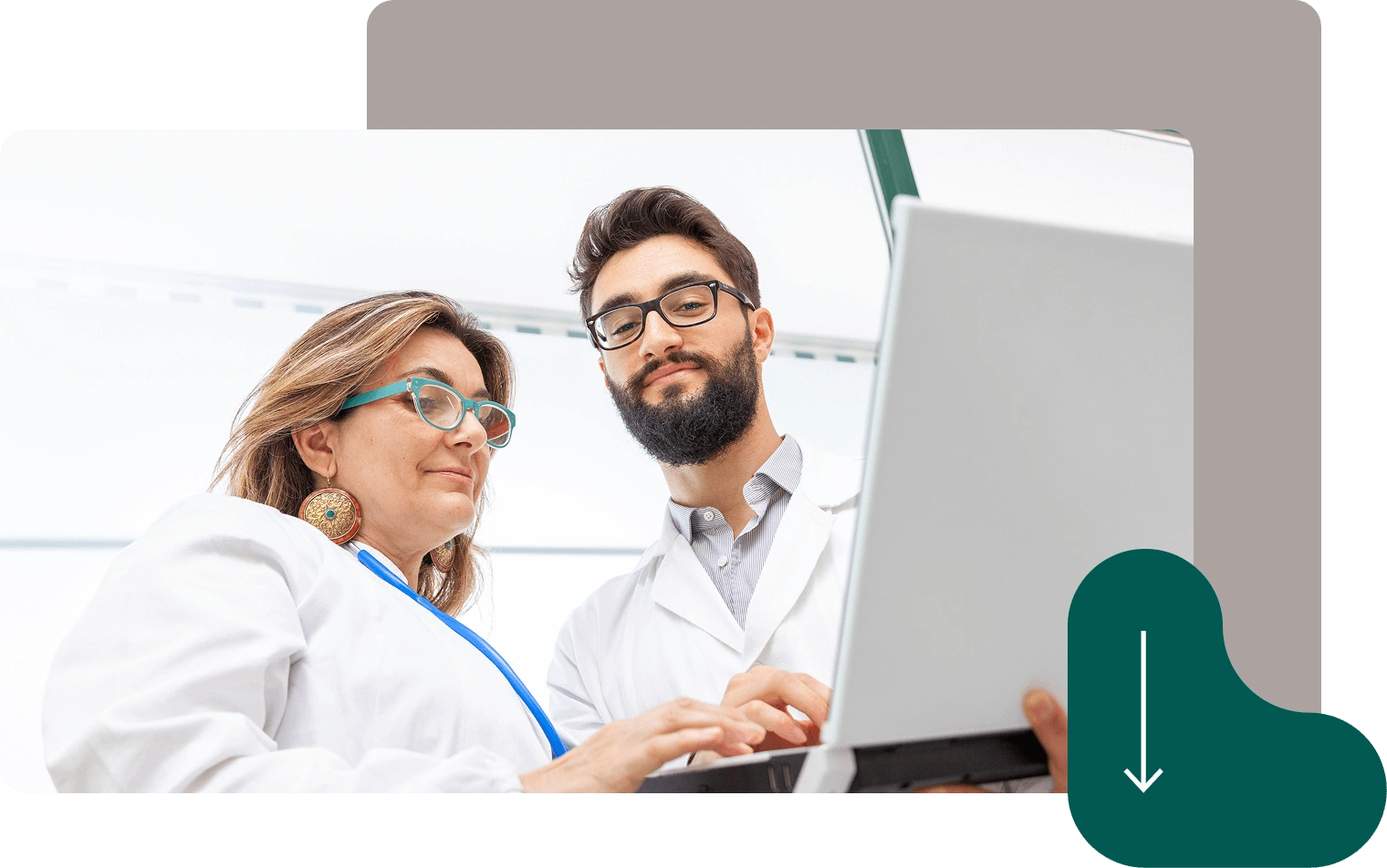 Two doctors in white coats using laptop computer for medical consultation